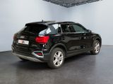 the rear end of a black audi suv parked in a garage
