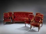 three chairs and a couch in a room with a dark background