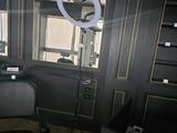 a black chair in front of a mirror in a room