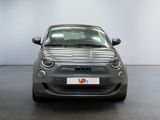the front view of a small grey car parked in a garage