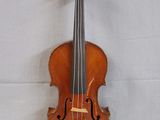 a violin that is sitting on a white surface