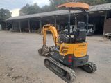 an image of a small excavator parked in front of a building