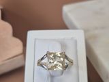 a diamond ring in a white box on a table