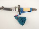 a blue tassel tied to the handle of a fire hydrant