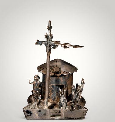 an image of a silver figurine of a boat with animals on it