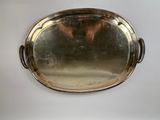 a silver tray with a handle on a white table