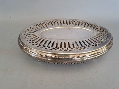 an antique silver plate with a decorative design on the rim