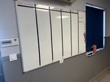a white board on the wall in a room