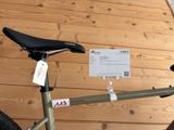 a bicycle that is sitting on the floor with a price tag