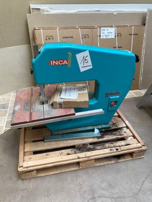 a blue machine that is sitting on a pallet