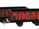an image of a toy train with a red wagon on it
