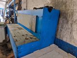 a blue bench in a dirty room with a blue wall