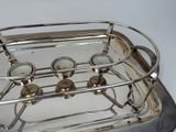 a silver tray with four cups on it on a table