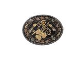 a close up of a black and gold broochle on a white background
