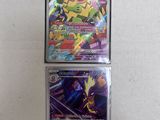 two pokemon cards are sitting on a table next to each other