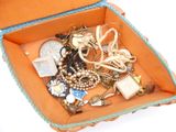 a box full of jewelry on a white surface