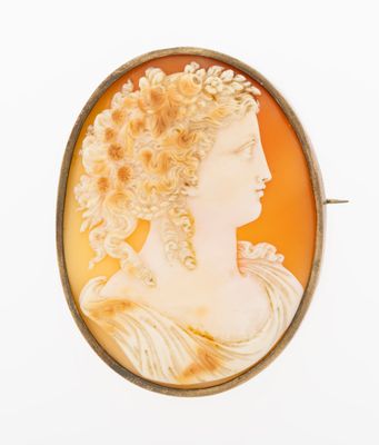 an antique cameo of a woman with flowers in her hair