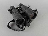 an image of a pair of binoculars sitting on top of a white surface