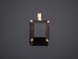 an image of a black diamond pendant on a gray background