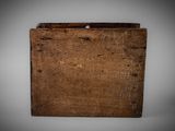 an old wooden box sitting on top of a white surface