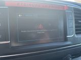 a picture of a car dashboard with a warning sign on it