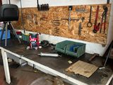 a workbench with tools on it in a garage