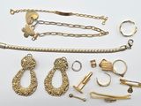 a lot of gold jewelry on a white surface