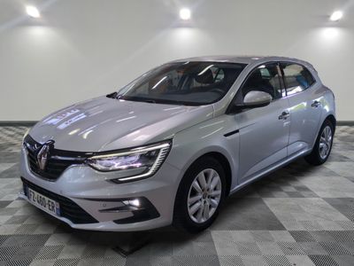 une voiture argentée garée dans une pièce au sol en damier
