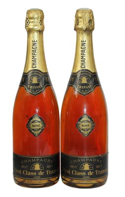 two bottles of champagne are sitting next to each other on a white surface