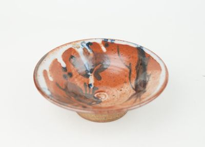 a small bowl that is sitting on a white surface