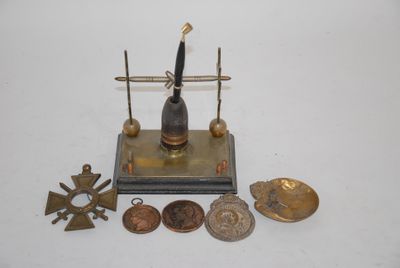 a small metal object with a clock on top of it