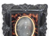 a picture of a man in a suit and tie in a picture frame