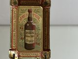 a miniature picture of a bottle of liquor on a miniature chair