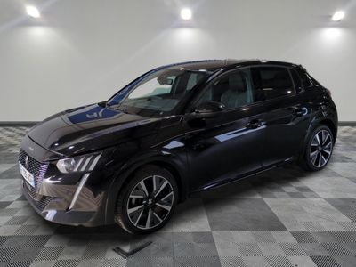 a black car is parked in a room with a checkered floor
