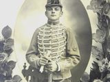 portrait of a man in a military uniform holding a rifle