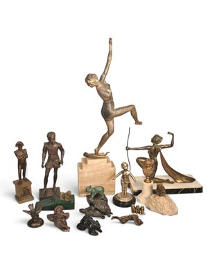 a lot of figurines that are sitting on a white surface