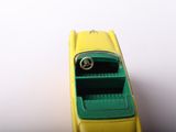 a yellow toy car that is sitting on a white surface