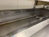 a stainless steel sink in the middle of a kitchen