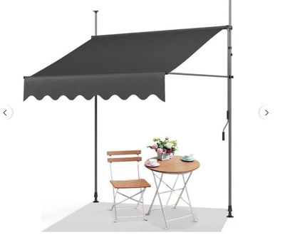 an image of a table and chairs under a black awning