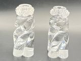 pair of clear glass figurines of a woman and a man