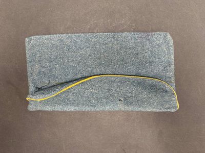 grey felt pouch with yellow thread on top of it