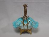 a small blue vase with a chain hanging from it ' s neck