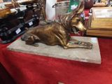 a statue of a dog sitting on a table