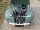 a green car that is parked on the side of the road