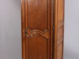 an antique wooden armoire with two drawers and a door
