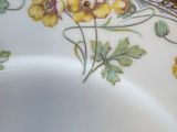 a close up of a plate with yellow flowers on it