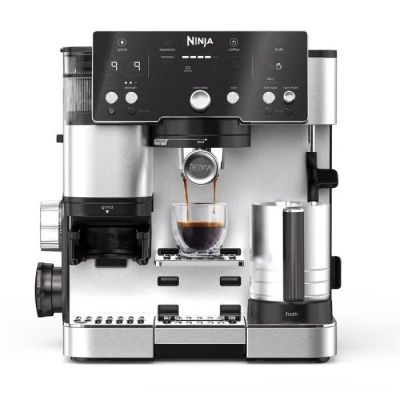 a close up of a coffee machine on a white surface