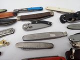 many different types of pocket knives on the table