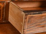 a wooden desk with two drawers and a clock on it
