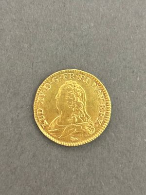 a gold coin with a woman ' s face on it